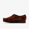 Wallabee voor dames. Bruine Wallabees met koeienprint
